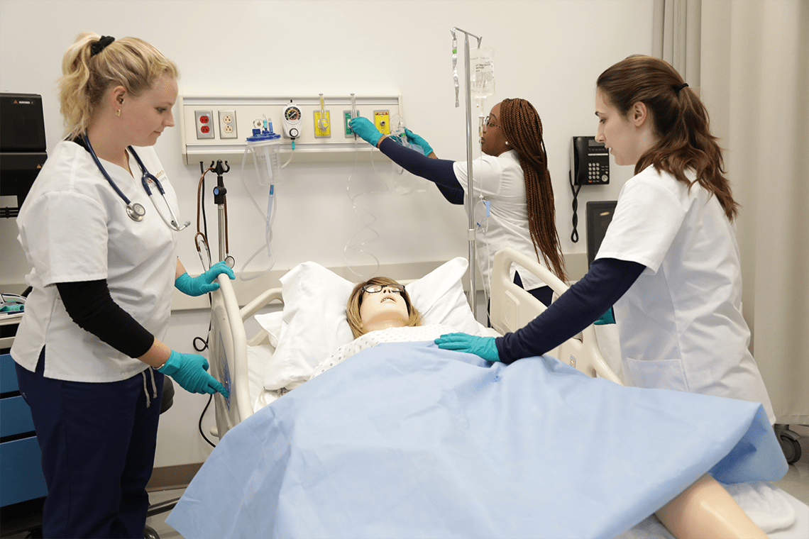 Northeastern nursing students working in sim lab