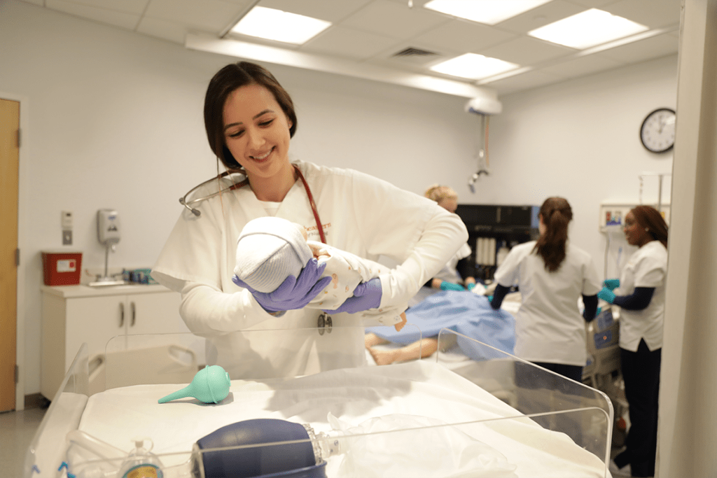 Northeastern nursing student working in sim lab