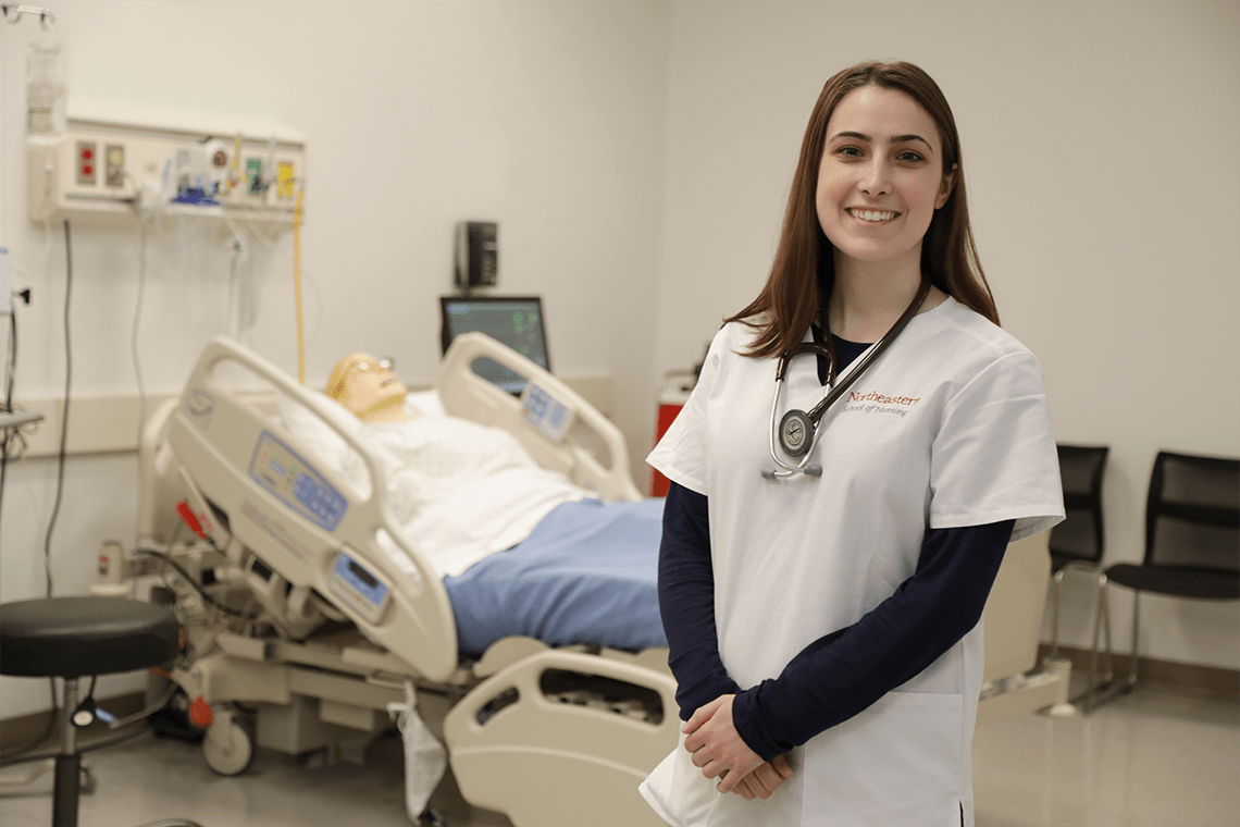 Northeastern nursing student smiling in lab