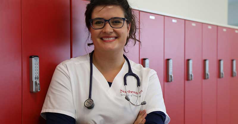 Northeastern ABSN student standing by lockers