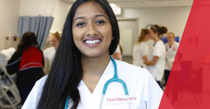 Northeastern ABSN student in white scrubs smiling