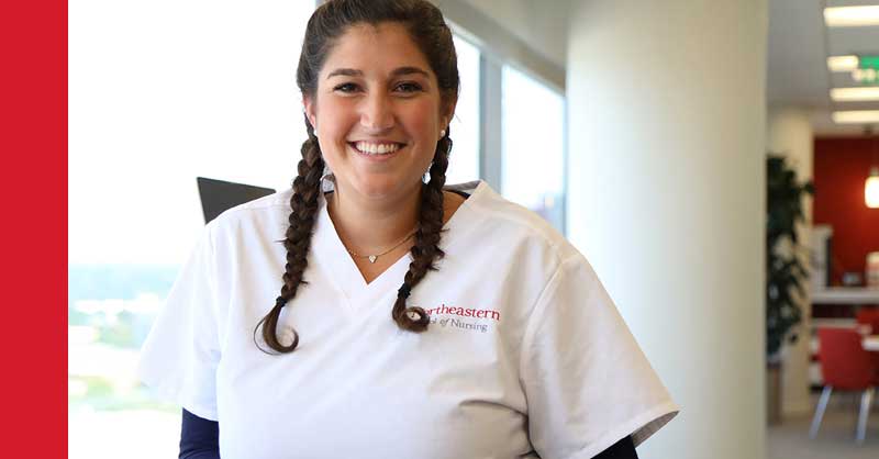 Northeastern ABSN student in white scrubs smiling