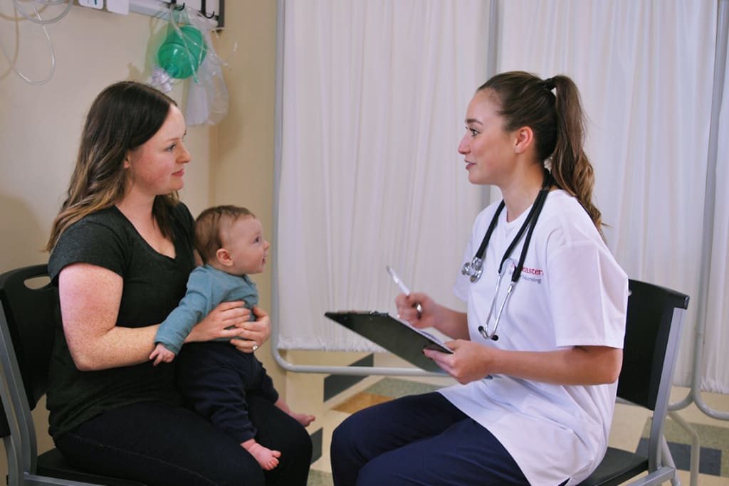 Northeastern ABSN student speaking with adult and child