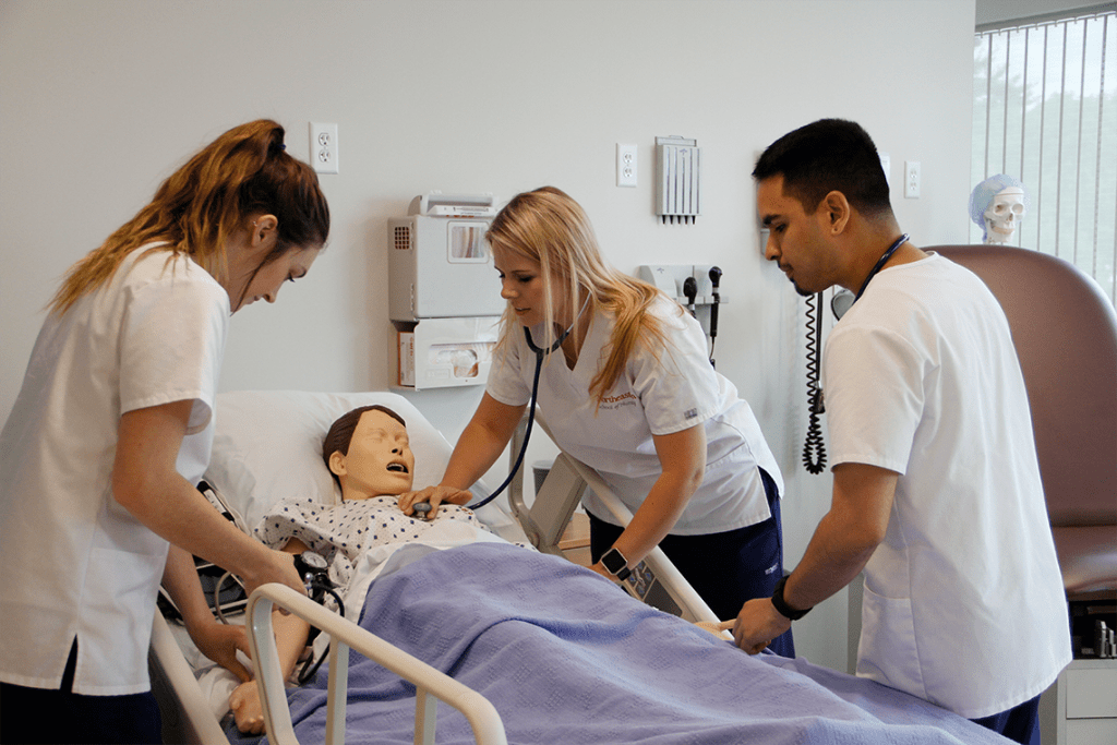 three Northeastern nursing students in sim lab