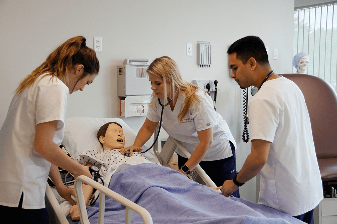 three Northeastern nursing students in sim lab