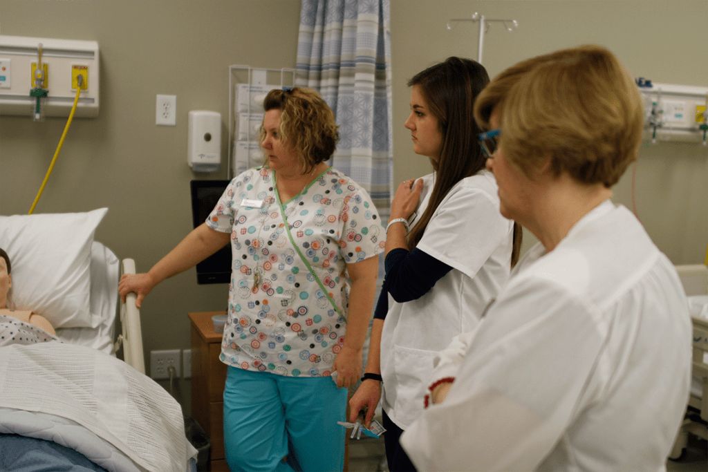 nursing students standing in lab