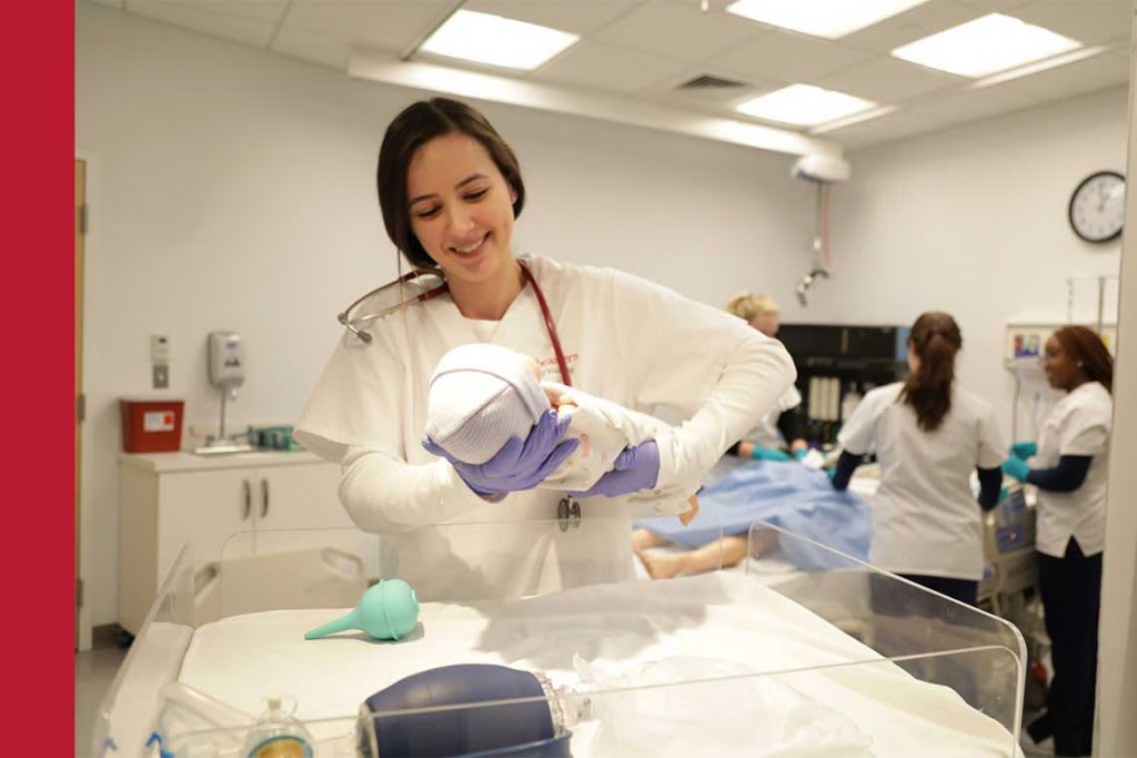 Northeastern nursing student working in sim lab