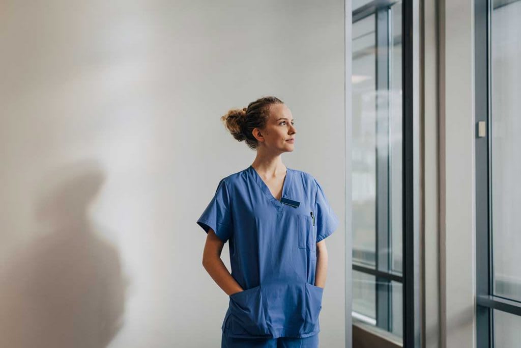 nurse standing by window