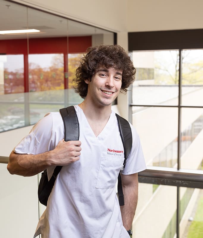 smiling neu nurisng student with backpack