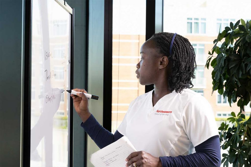 Northeastern nursing writing on whiteboard