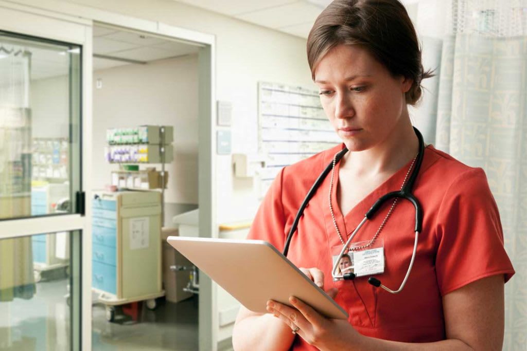 nurse with tablet in hospital setting