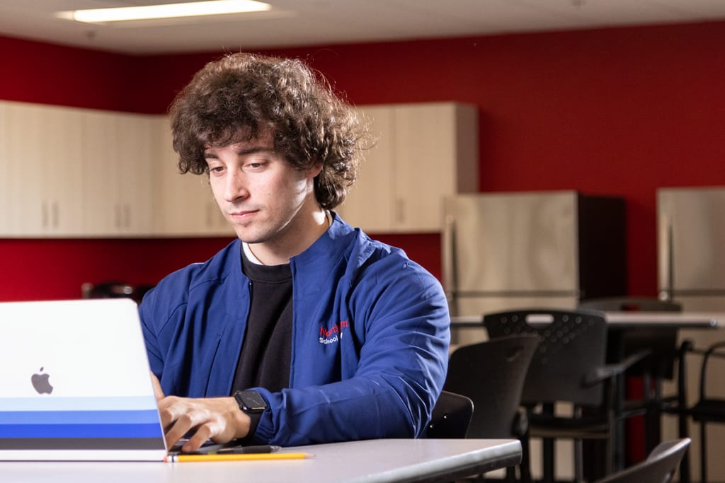 nurse studying on laptop