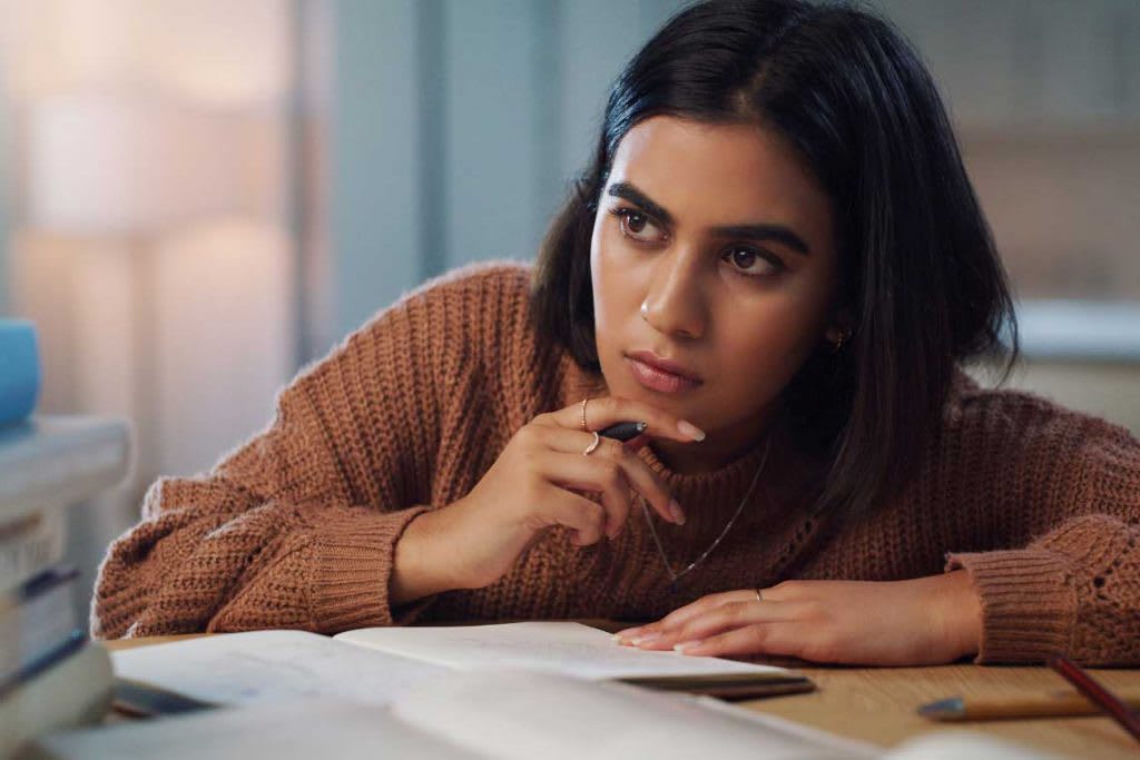 woman sitting at desk looking intently