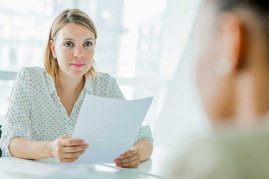 woman in interview holding resume