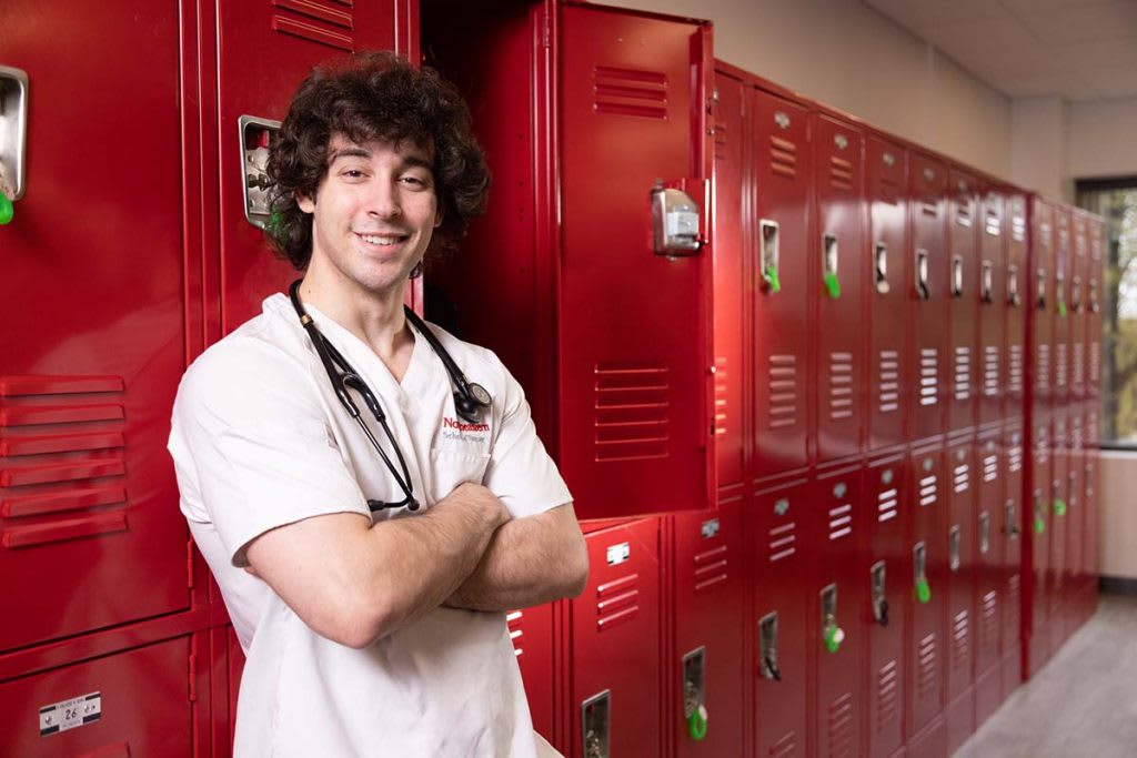 student nurse in front of lockers