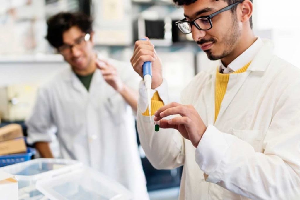 two men in lab using lab equipment