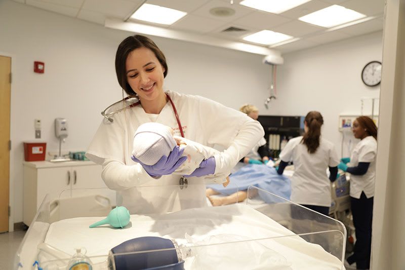 Northeastern University - Nurse holding baby