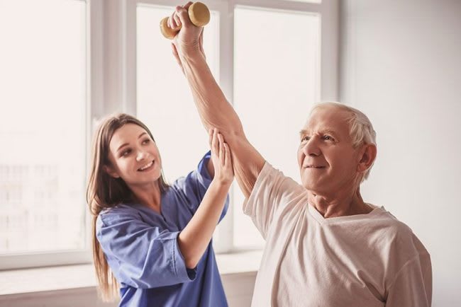 Physical Therapy - patient lifting weight