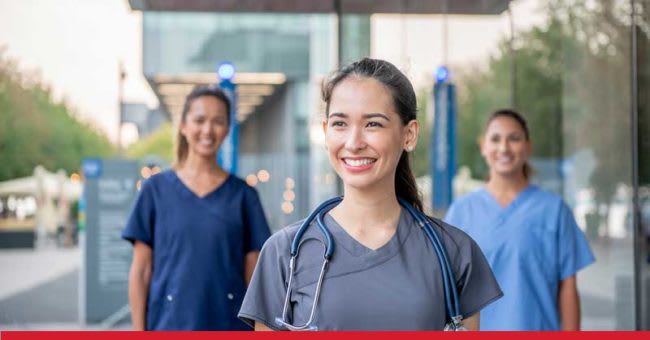 three nurses standing outside