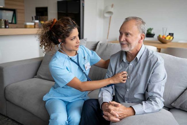 nurse checking patient's heartbeat