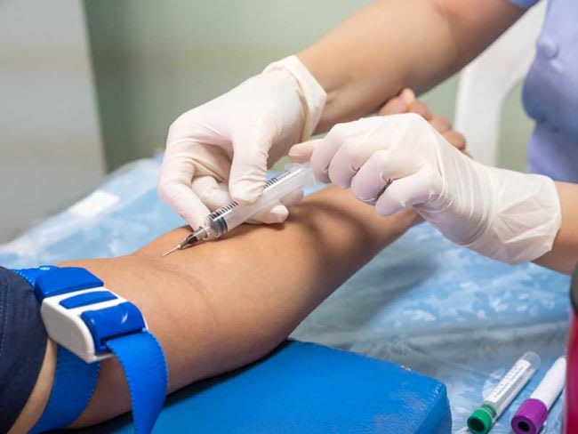 Nurse with syringe and patient