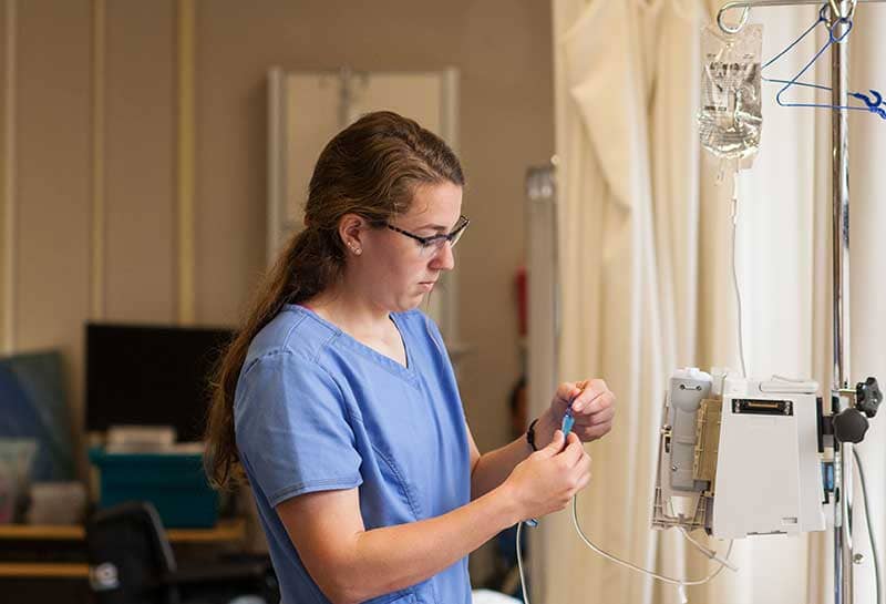 nurse in scrubs working with IV