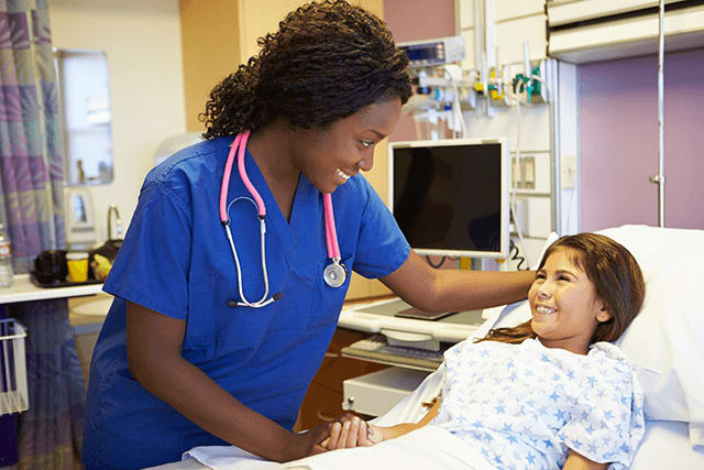 nurse visiting patient in hospital bed