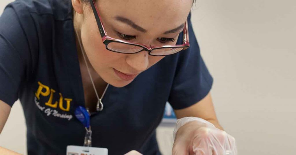 close-up of nursing student working in sim lab