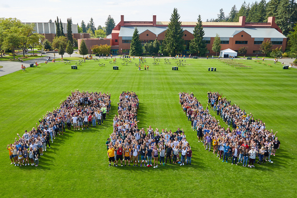 birds eye view of students outside on campus forming letters P, L, and U