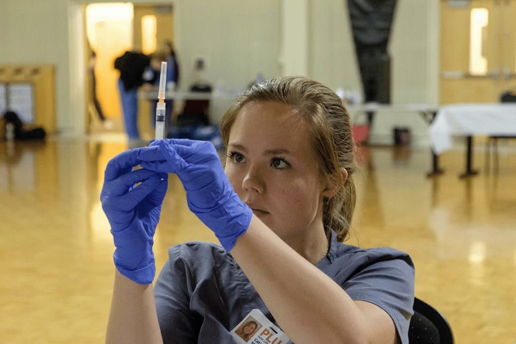 PLU ABSN student filling a syringe