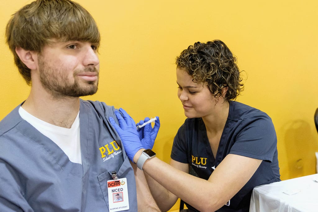 PLU nursing students practicing skills in lab