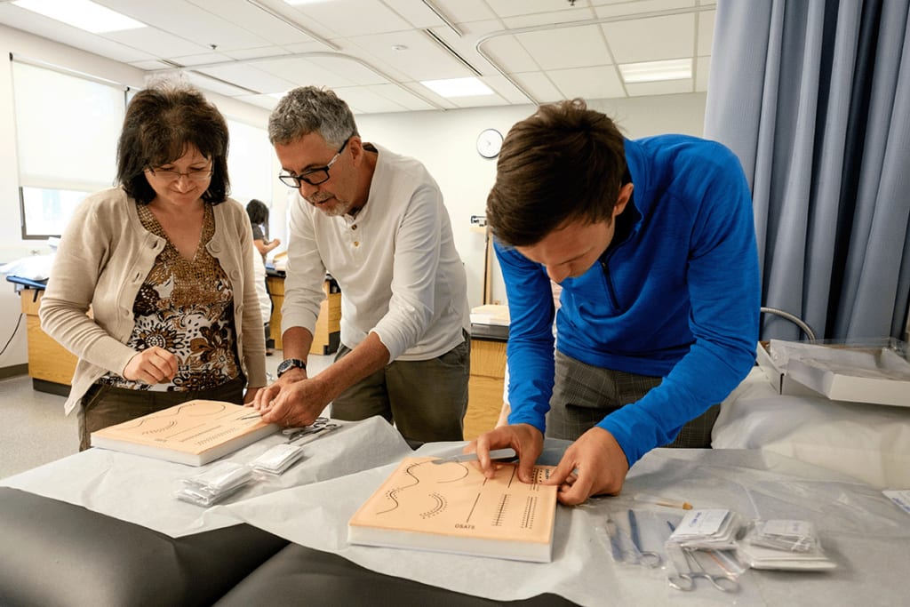 nursing students practicing suturing