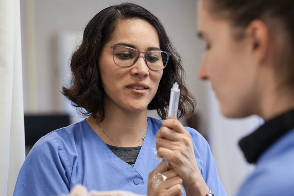 nursing student holding a syringe