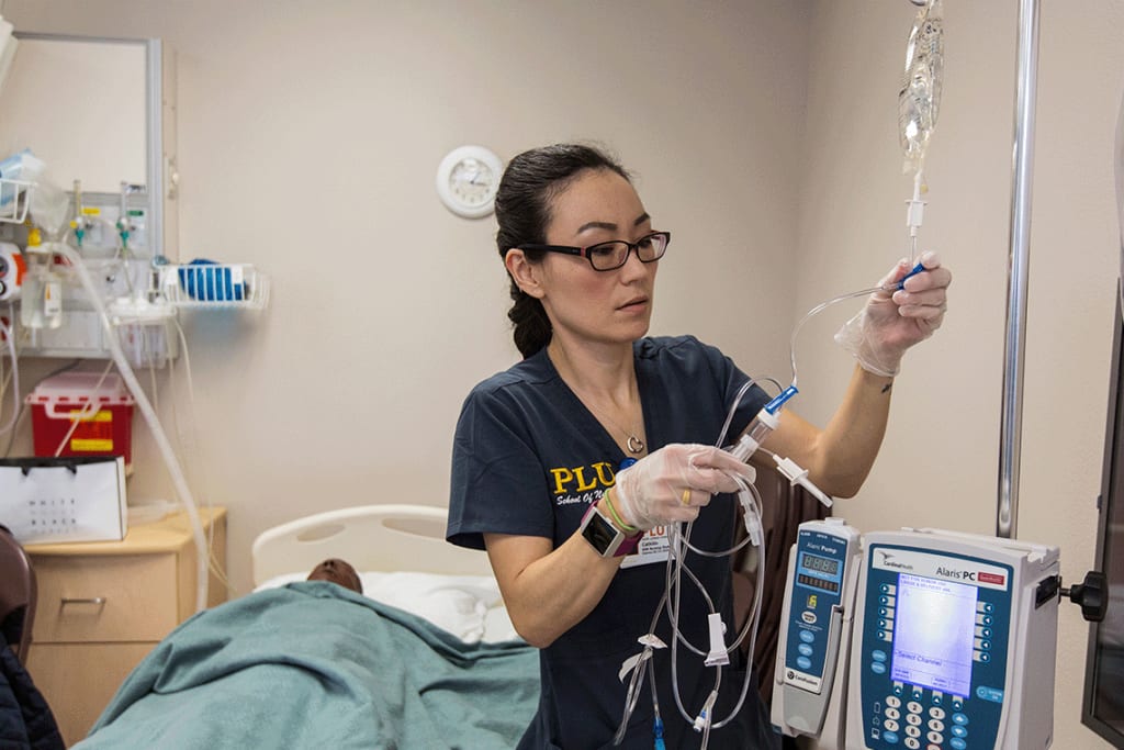 PLU ABSN student holding IV