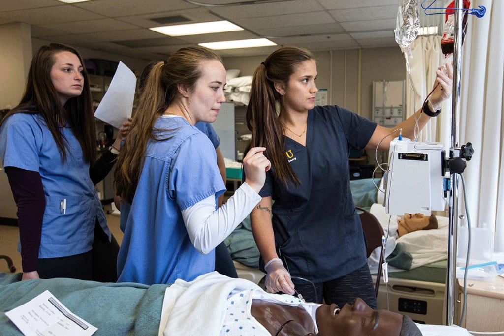 PLU ABSN students looking at IV