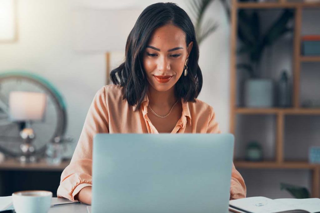 woman sitting at desk with laptop