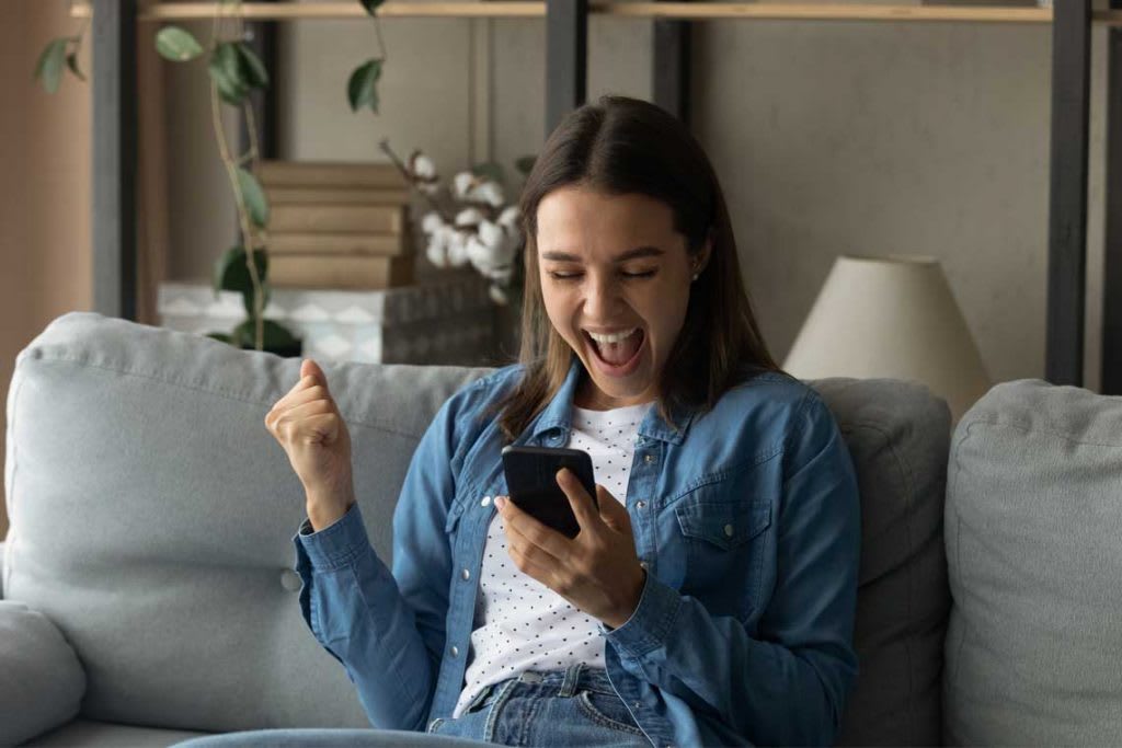 woman looking at phone excited