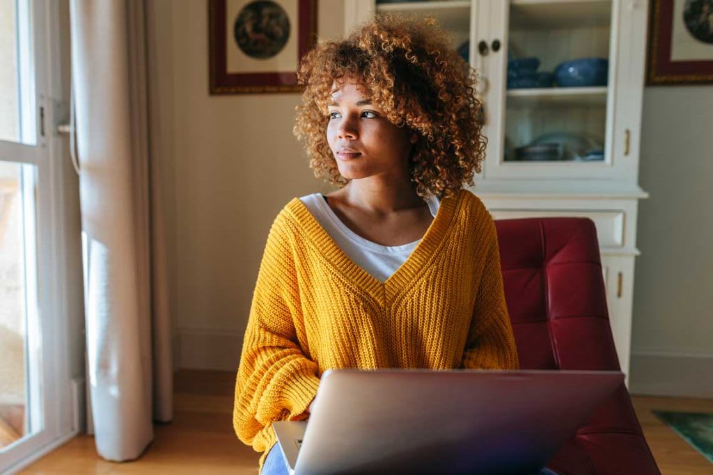 woman on couch using laptop