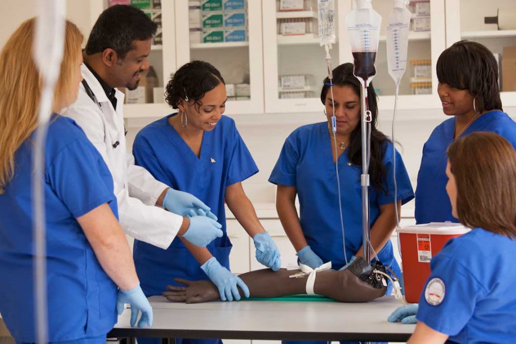 Nurses gathered around manikin