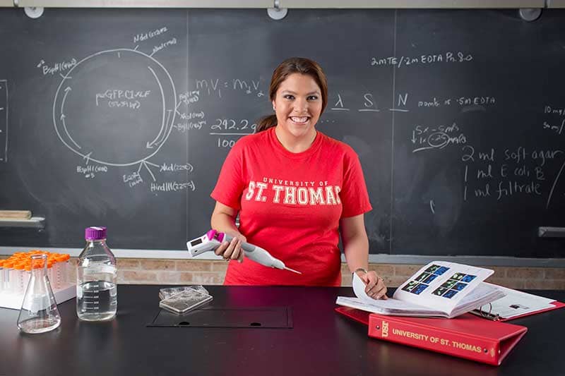 nursing student standing in front of blackboard