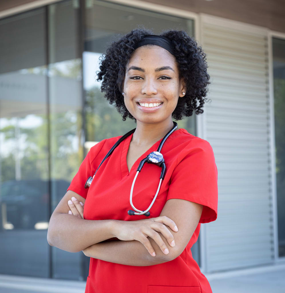 person with arms crossed smiling