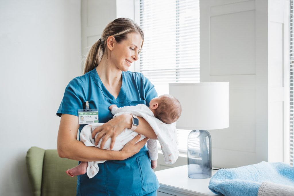 labor and delivery nurse holding baby