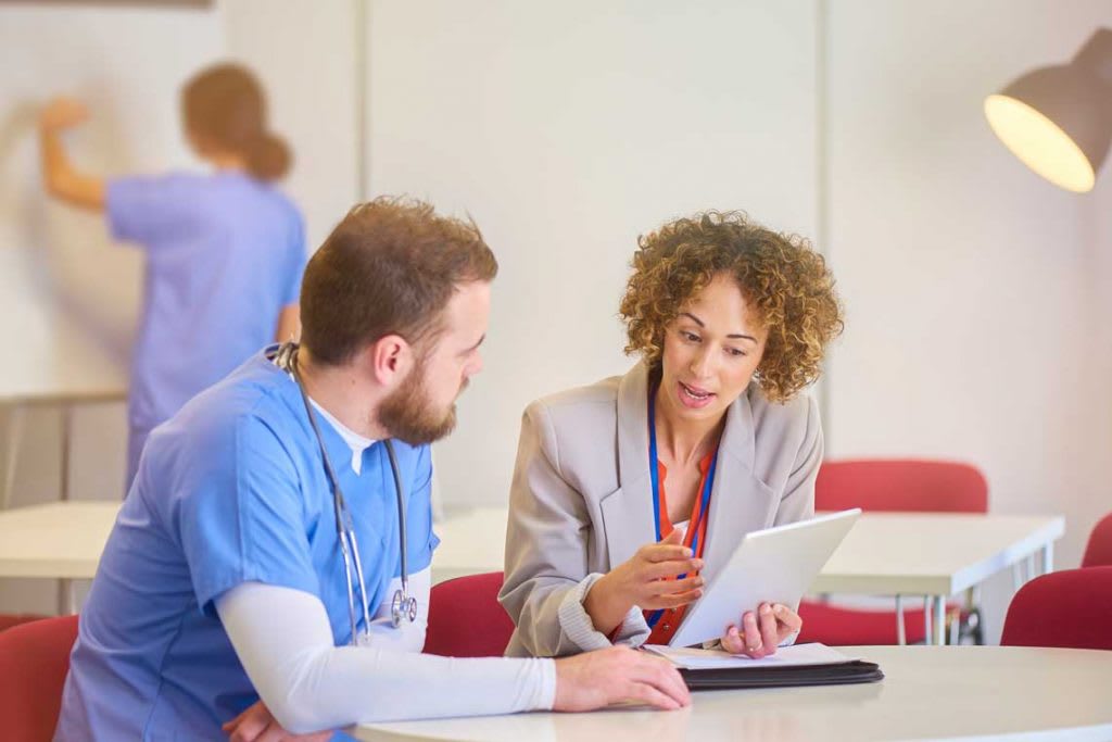 nursing school student sitting with admissions counselor