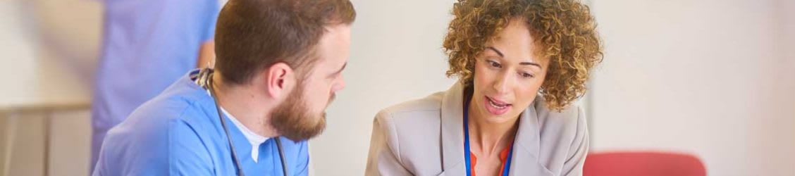 nursing school student sitting with admissions counselor