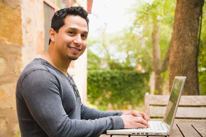 male student studying on a computer