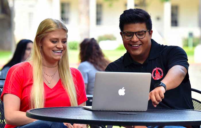 a UIW admissions interview outside in front of a computer