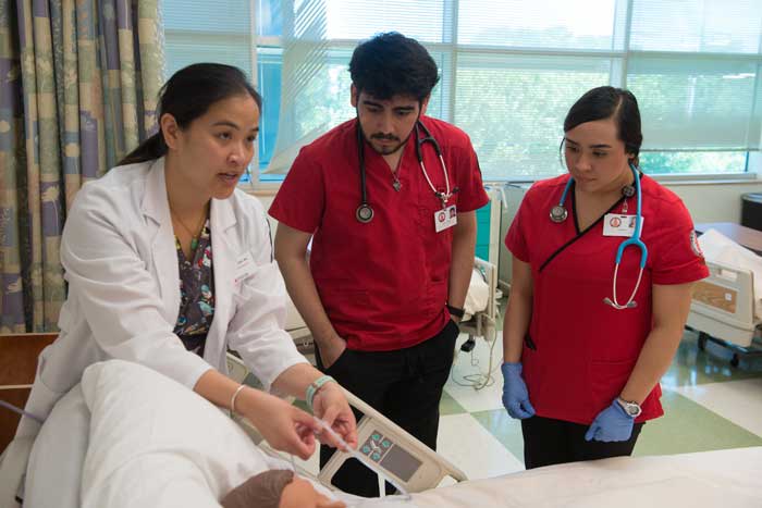 UIW professor with two nursing students during a simulation lab