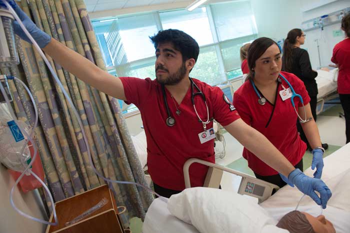 UIW nursing student in a simulation lab with peers