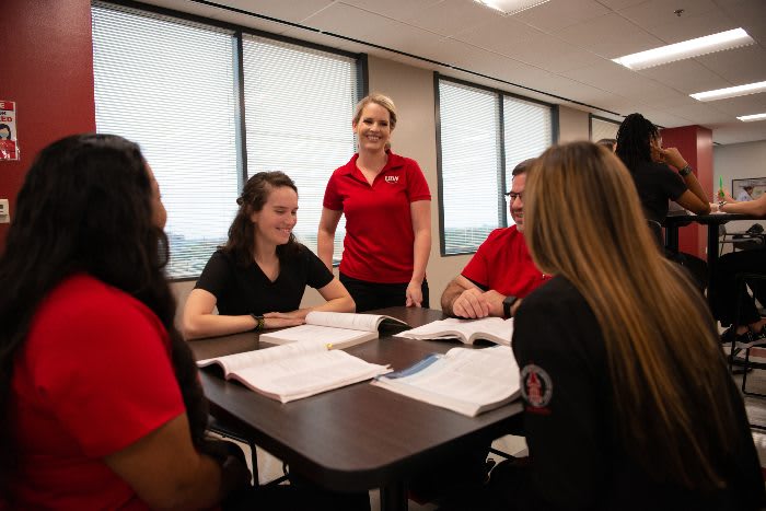 UIW ABSN students sitting at a table and studying together