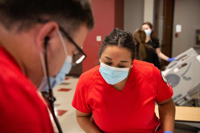 University of the Incarnate Word ABSN students in red scrubs